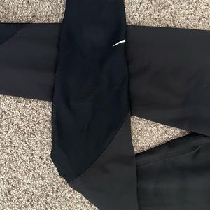 Nike Dri Fit , mid calf legging with mesh detail in side and back of calf.